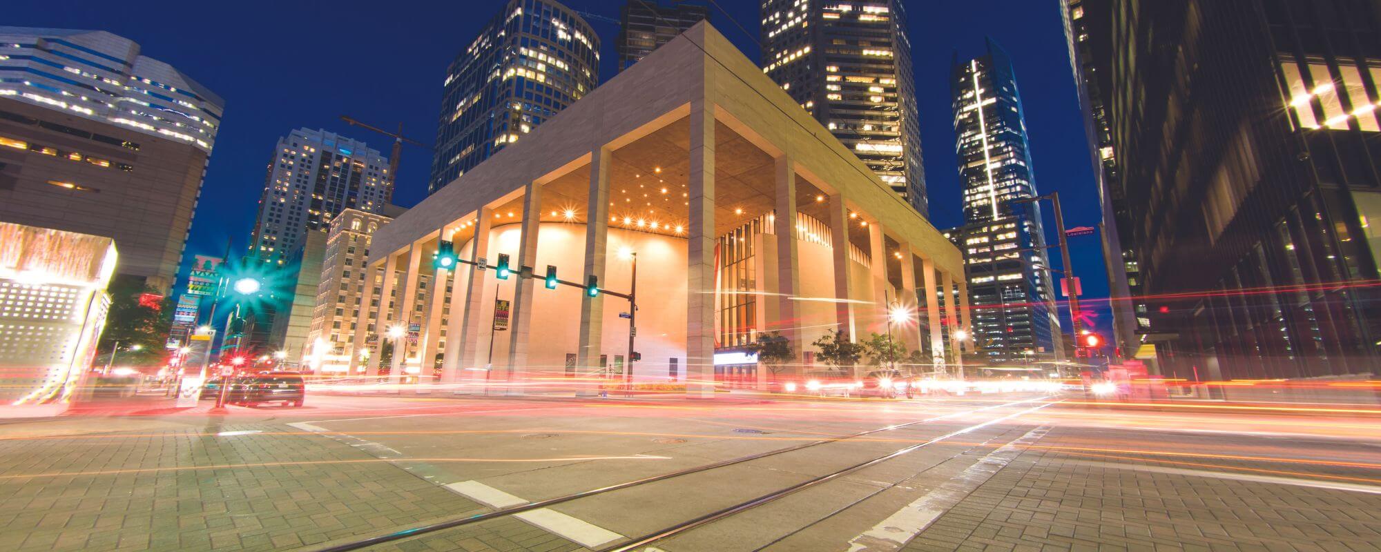 Performing Arts Houston building. A tall white building with white pillars all around.